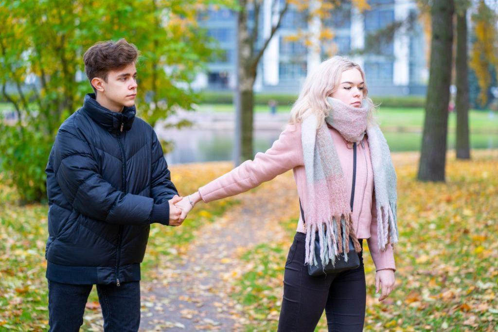 3 Things You Shouldn't Do If You Want a Healthy Relationship 1 two teenagers in love in quarrel the blonde girl takes offense at boy the guy holds her hand asks the t20 Wx0BAg